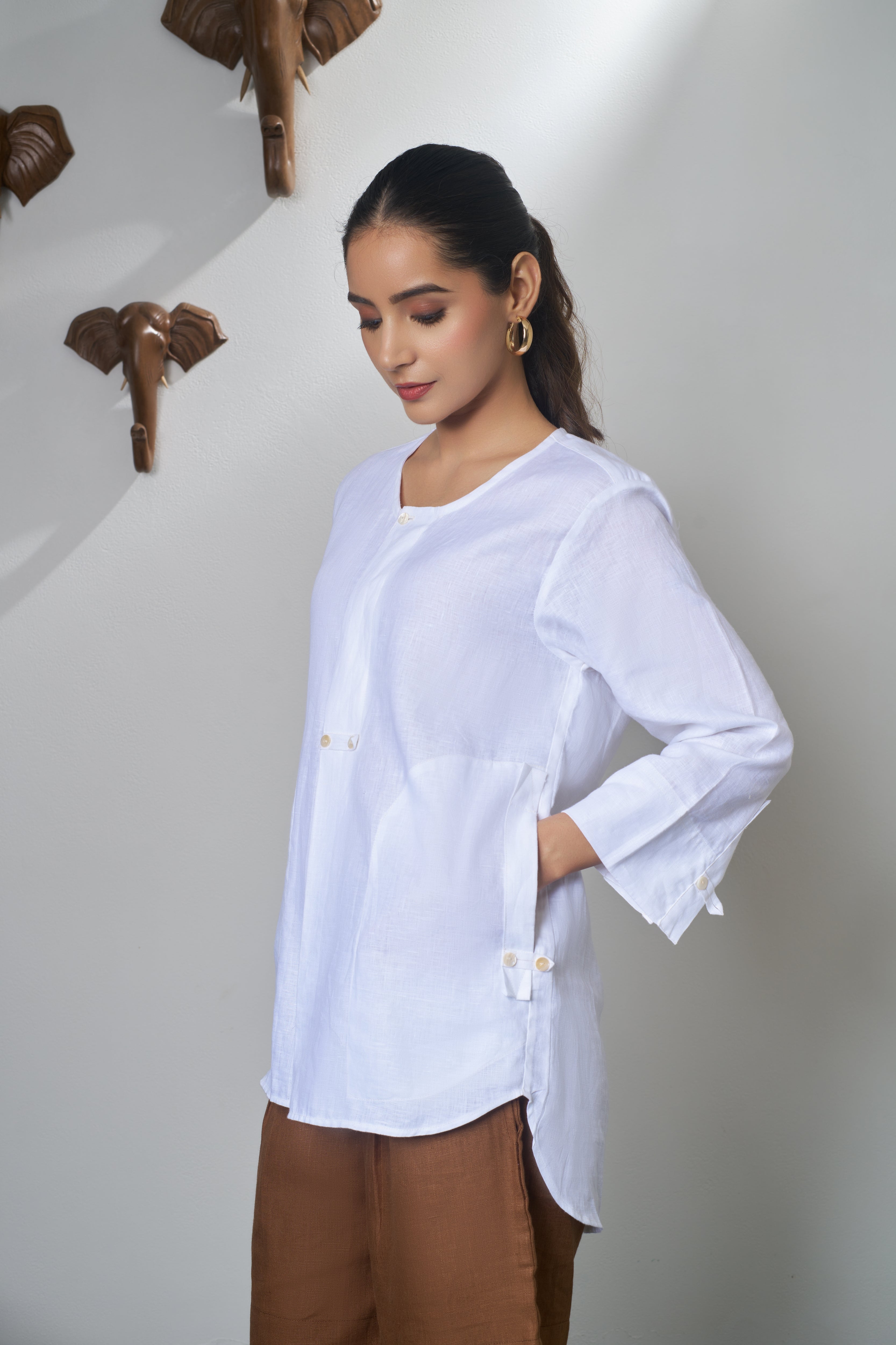 Woman wearing a white shirt and brown shorts. Linen clothing mumbai, 
Casual linen fashion