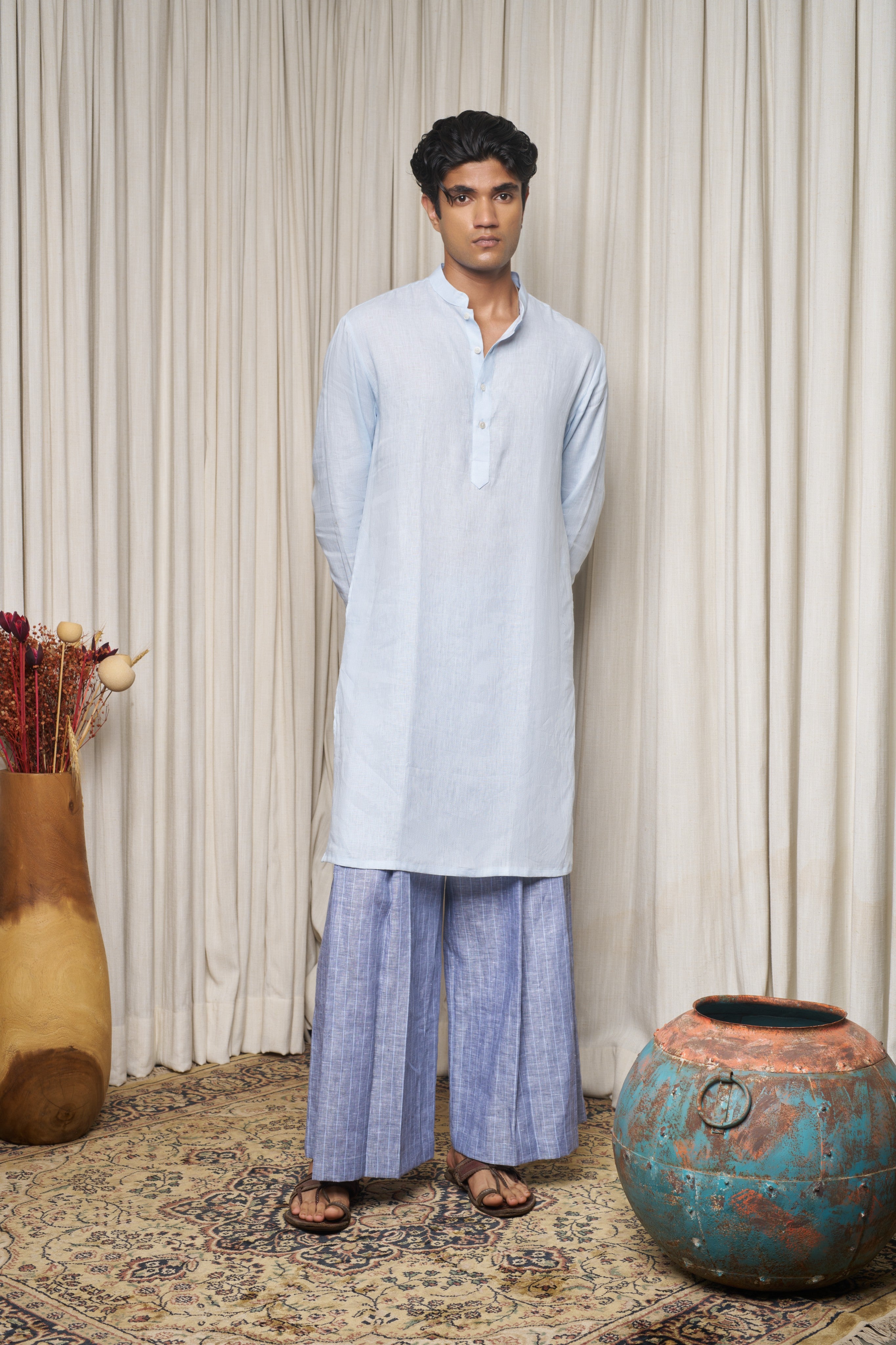 Man wearing a white traditional outfit, ethical men’s fashion India, slow fashion menswear