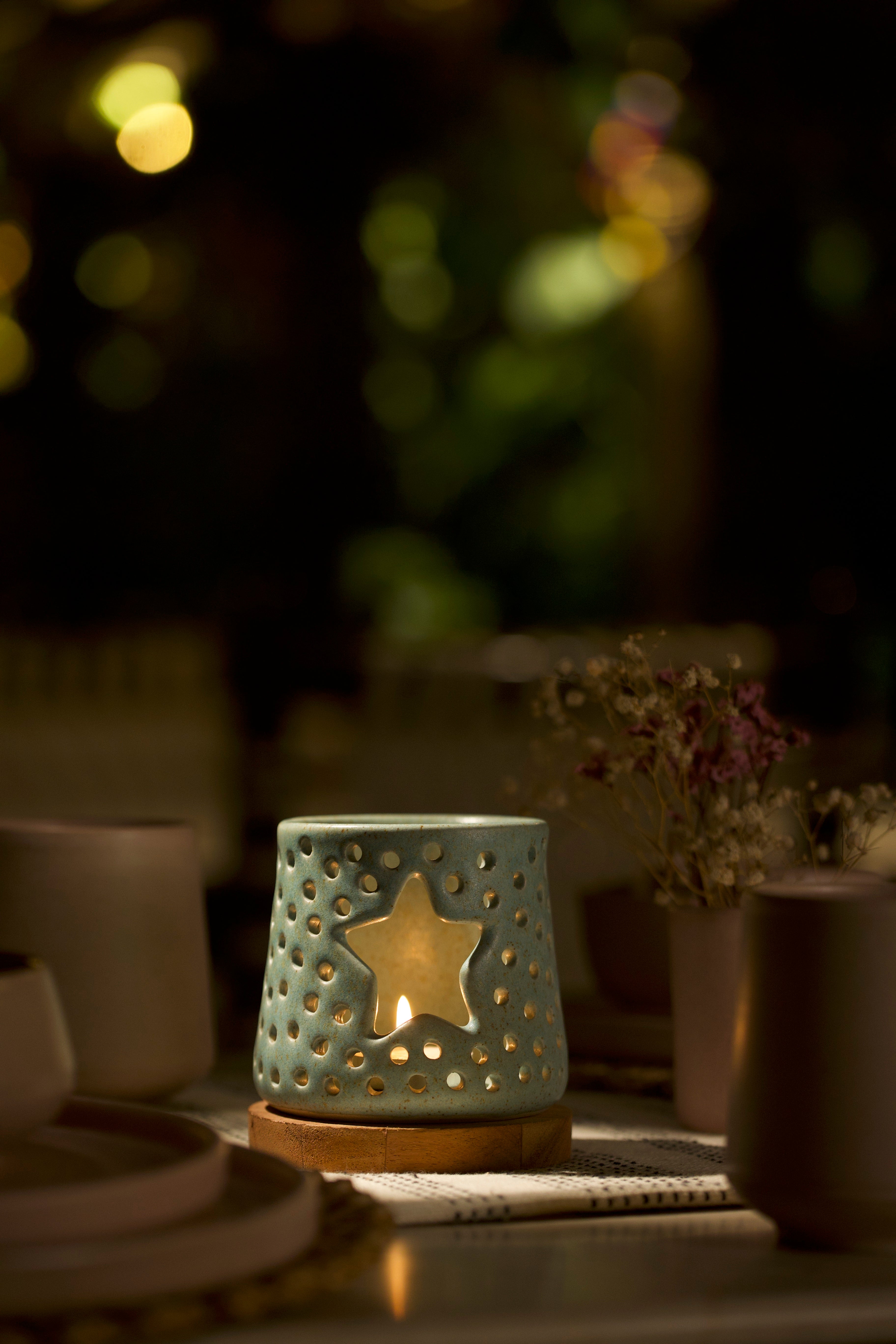 A mint decorative ceramic lantern with intricate design.  ceramic home décor online, minimalist home décor India
