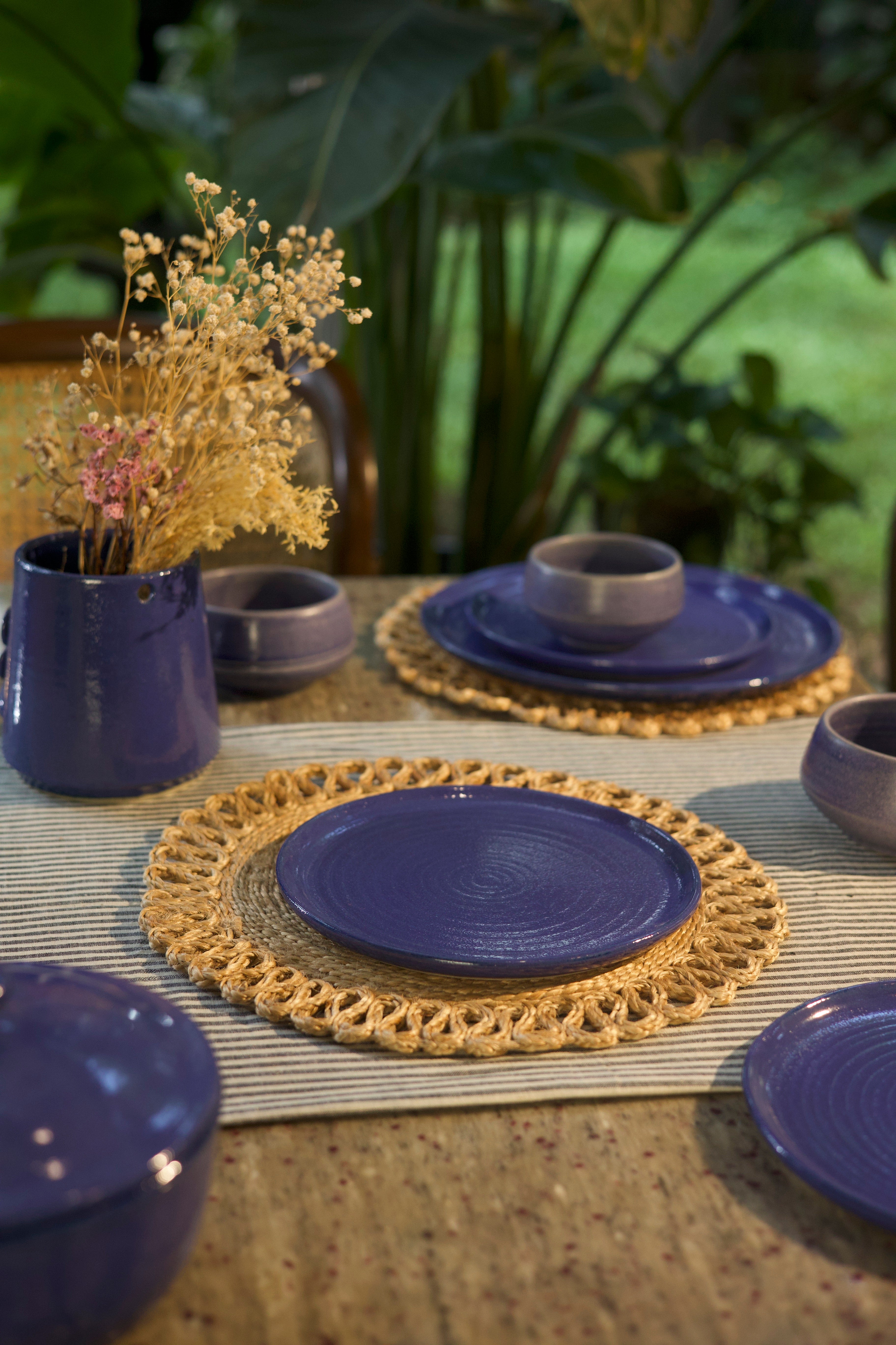 Blue ceramic plates and bowls on a textured surface  handmade dinnerware India, handcrafted plates and bowls