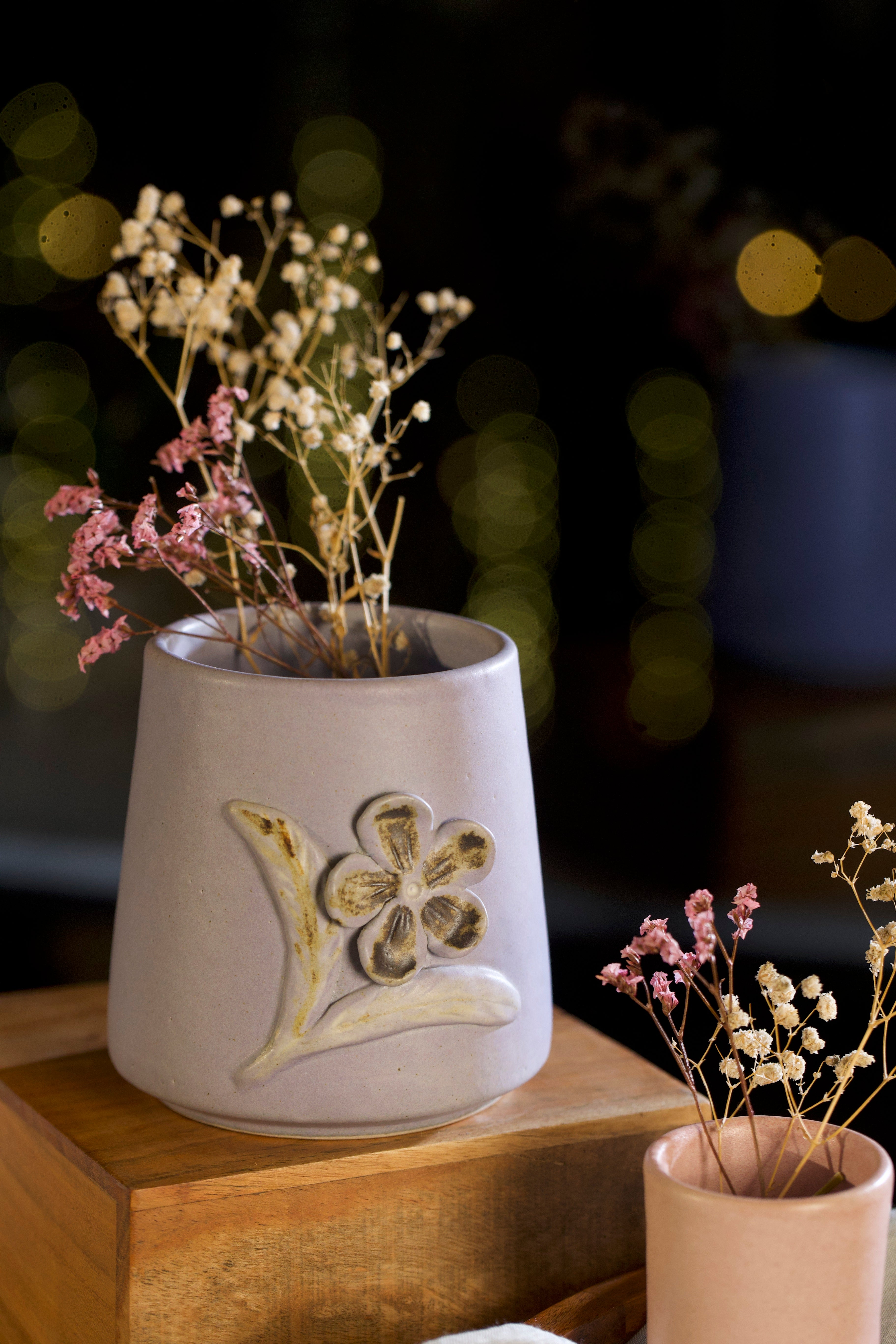 Ceramic vase with floral design on a wooden surface, pottery home decor,  
handmade clay planters