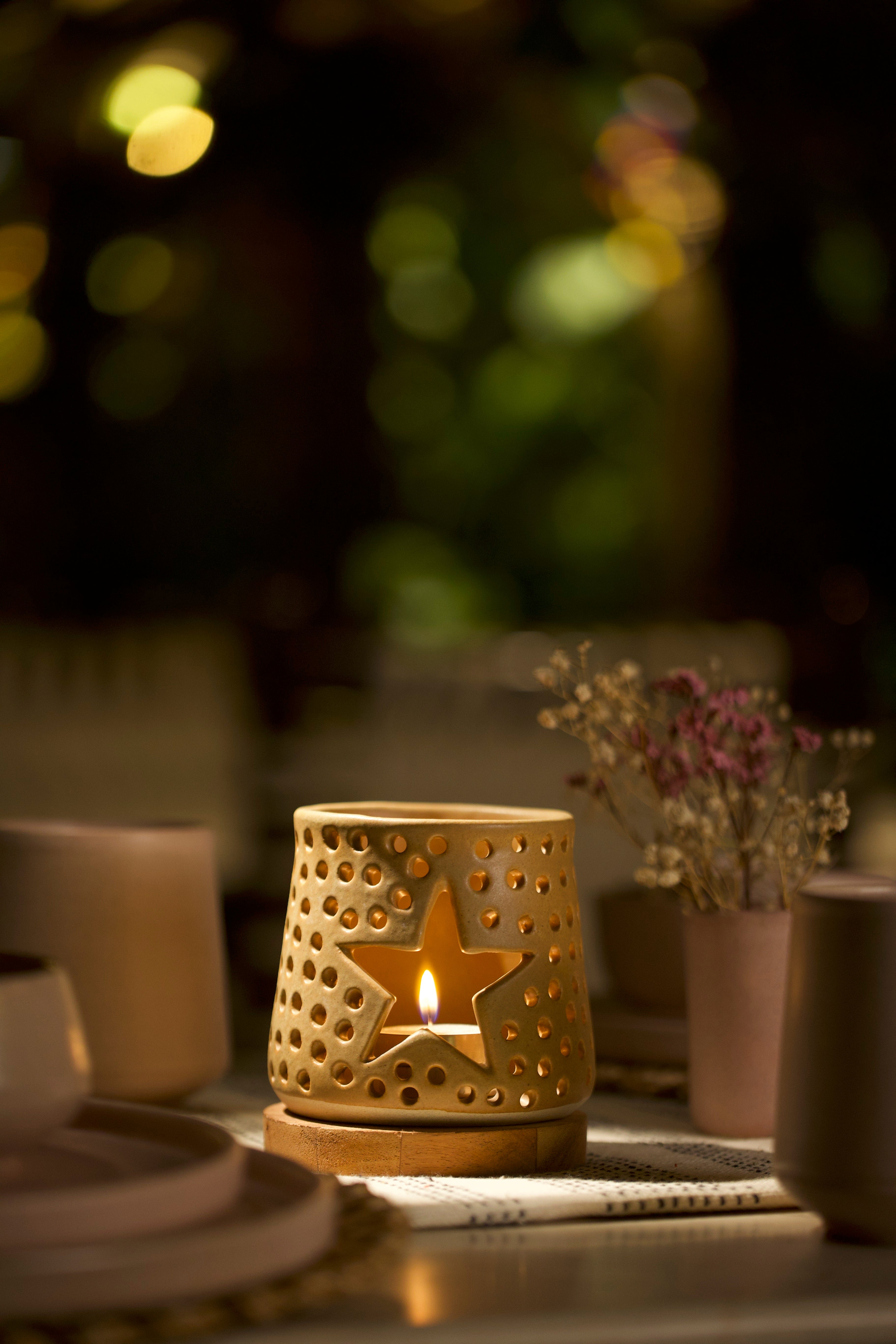 A mustard decorative ceramic lantern with intricate design.  ceramic home décor online, minimalist home décor India

