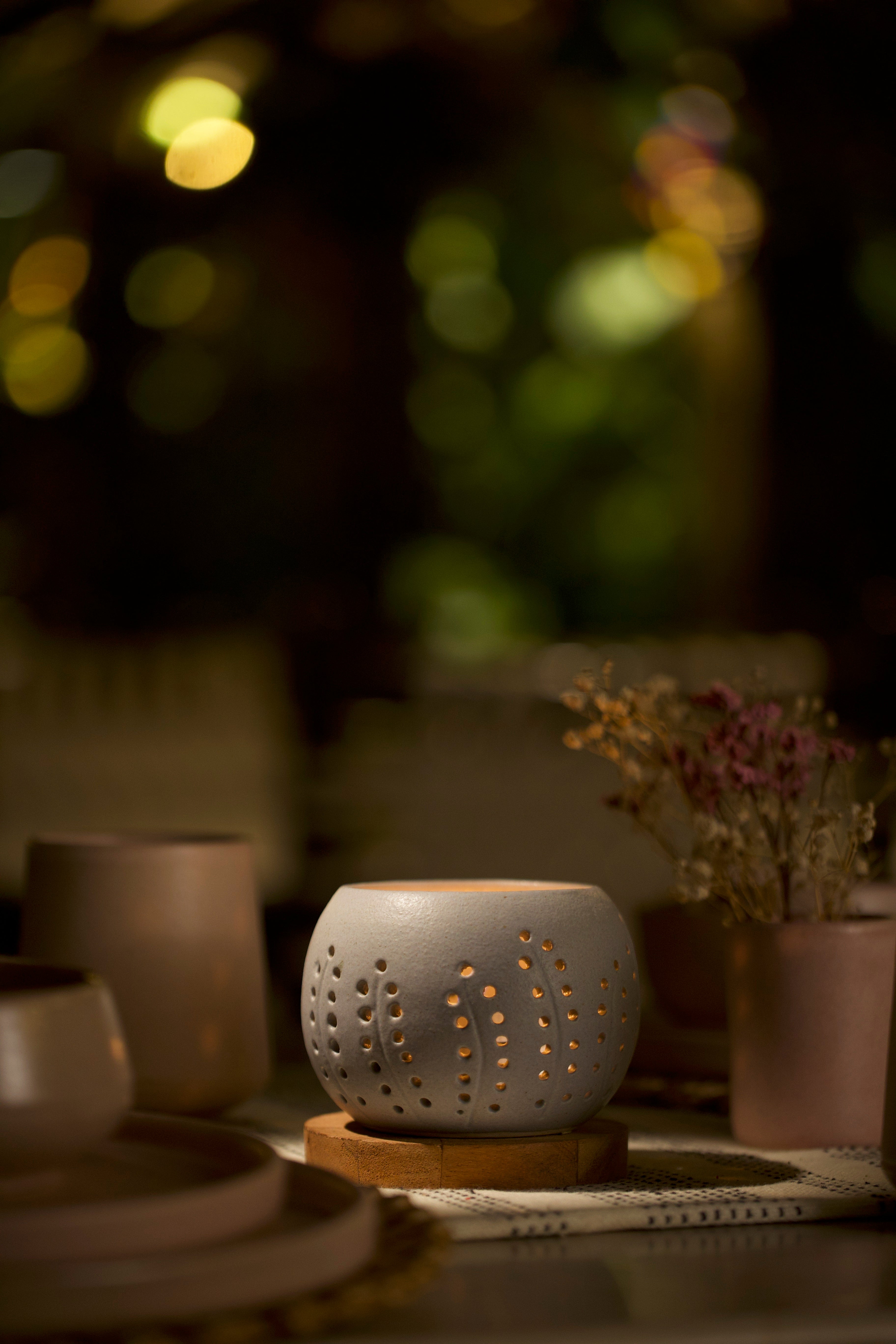 A white decorative ceramic pot with intricate design. Home decor shop online, artisanal home décor India