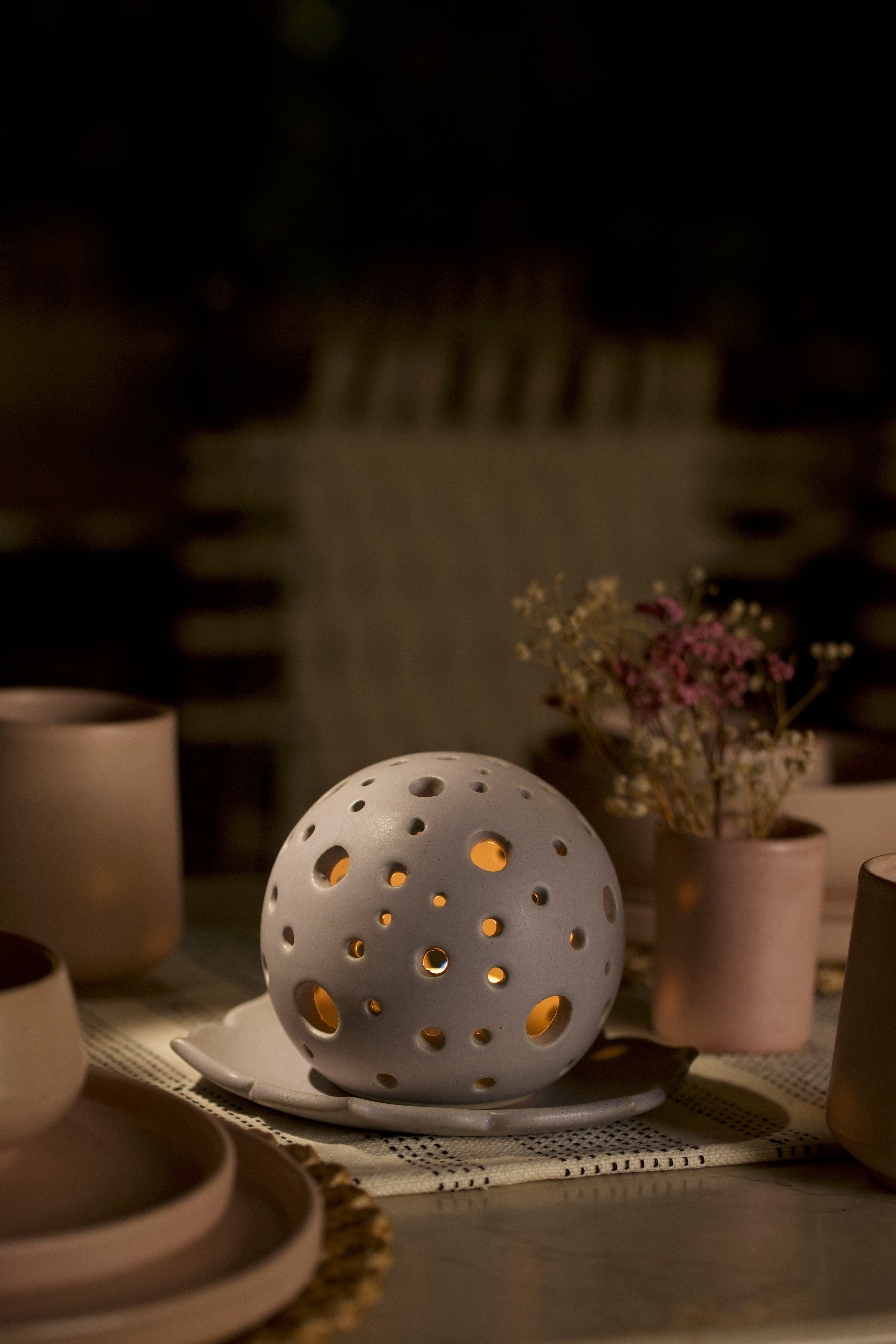 A white decorative ceramic pot with intricate design. minimalist home décor India, handmade ceramics India
